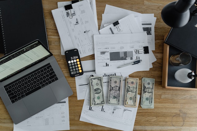 money-with-paper-and-laptop-Financial-Management